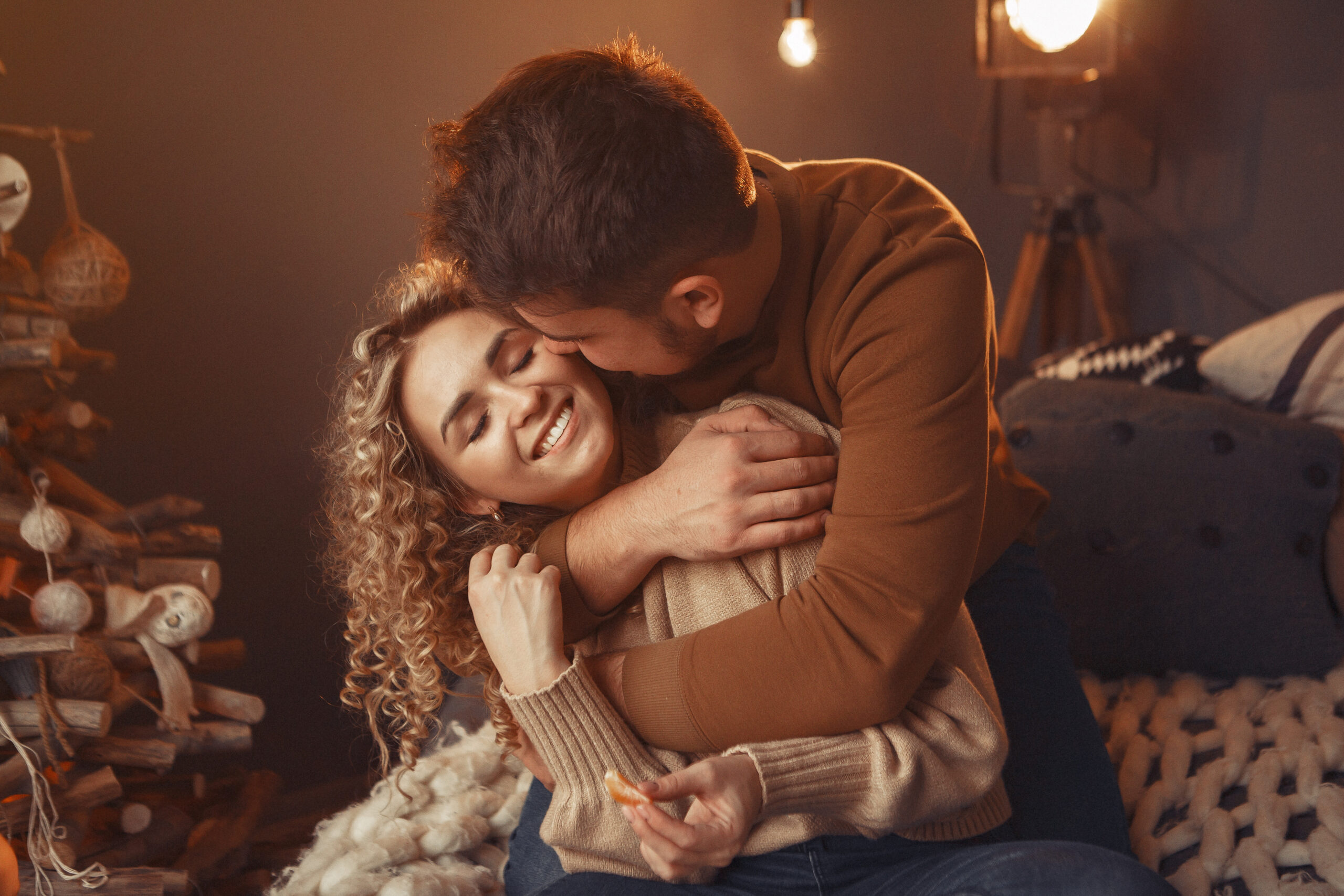 elegant couple sitting at home near christmas tree